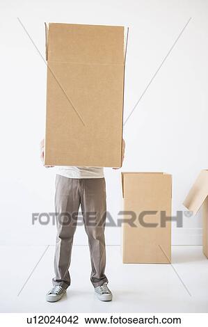 Mid adult man hiding inside of cardboard box View Large Photo Image Stock Image - Mid adult man hiding inside of cardboard box. Fotosearch