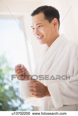 Mid adult man mixing herbal tea View Large Photo Image Stock Image - Mid adult man mixing herbal tea. Fotosearch