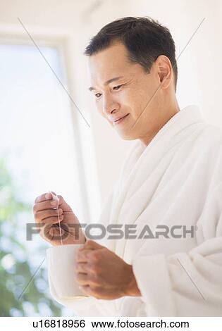 Mid adult man mixing herbal tea View Large Photo Image Stock Photograph - Mid adult man mixing herbal tea. Fotosearch