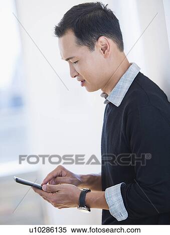 Mid adult man text messaging View Large Photo Image Stock Photography - Mid adult man text messaging. Fotosearch