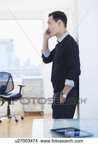 Mid adult using mobile phone View Large Photo Image Picture - Mid adult using mobile phone. Fotosearch