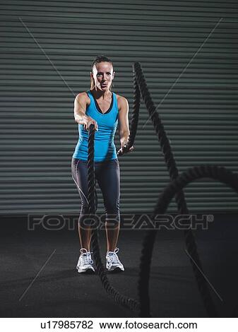 Mid adult woman exercising with rope View Large Photo Image Stock Image - Mid adult woman exercising with rope. Fotosearch