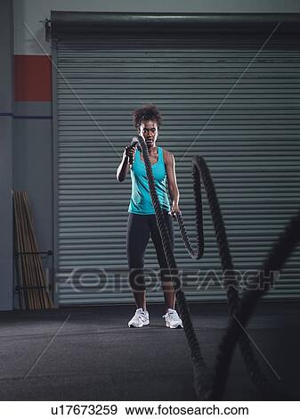 Mid adult woman exercising with rope View Large Photo Image Stock Photo - Mid adult woman exercising with rope. Fotosearch