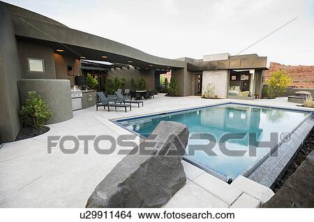 Picture - Modern luxury home facing swimming pool. Fotosearch