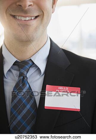 Office worker with name tag on suit View Large Photo Image Stock Image - Office worker with name tag on suit. Fotosearch