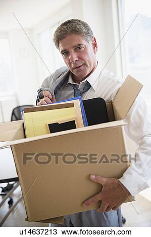 Office worker with packed carton box View Large Photo Image Stock Image - Office worker with packed carton box. Fotosearch