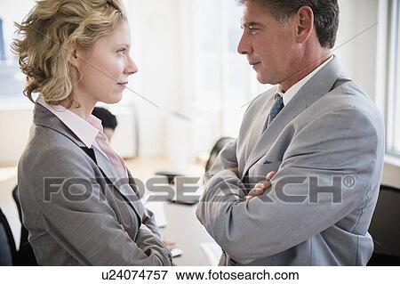 Stock Photo - Office workers discussing issues. Fotosearch