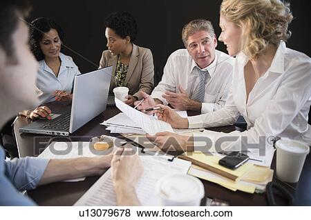 Office workers during discussion View Large Photo Image Stock Photo - Office workers during discussion. Fotosearch