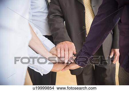 Office workers holding hands View Large Photo Image Picture - Office workers holding hands. Fotosearch