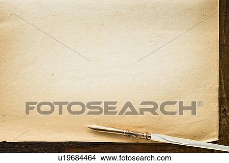 Picture - Old brown paper with fountain pen, studio shot. Fotosearch