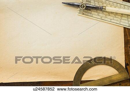 Stock Image - Old brown paper with protractor, studio shot. Fotosearch