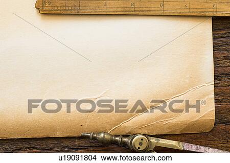 Picture - Old brown paper with ruler and compass, studio shot. Fotosearch