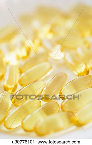 Stock Image - Omega fatty acid pills on white background, studio shot. Fotosearch