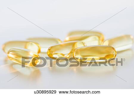 Stock Photo - Omega fatty acid pills on white background, studio shot. Fotosearch