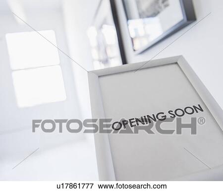 Opening sign with pictures on white wall in background View Large Photo Image Stock Photo - Opening sign with pictures on white wall in background. Fotosearch