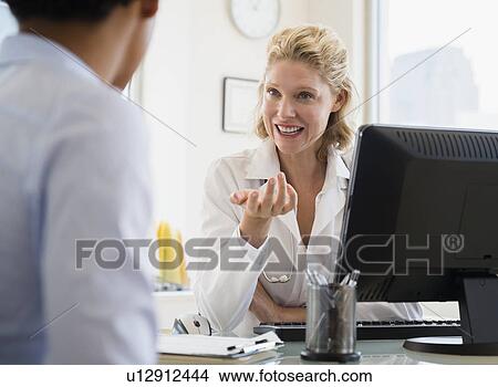 Picture - Patient during consultation with female doctor. Fotosearch