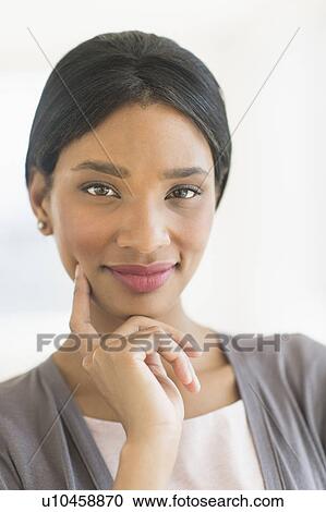 Stock Image - Portrait of businesswoman, studio shot. Fotosearch