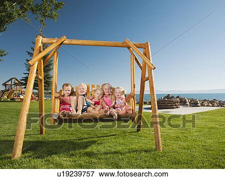 Stock Photo - Portrait of children (2-3, 4-5) swinging. Fotosearch