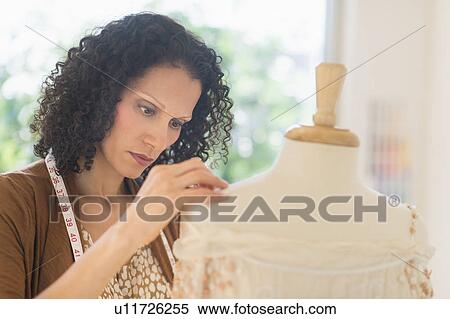 Portrait of clothes designer during work View Large Photo Image Stock Photography - Portrait of clothes designer during work. Fotosearch