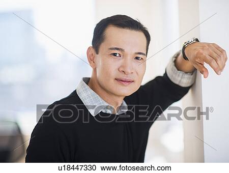 Stock Image - Portrait of confident mid adult man. Fotosearch