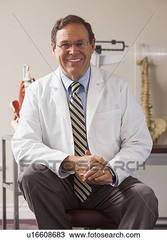 Portrait of doctor in his office View Large Photo Image Stock Image - Portrait of doctor in his office. Fotosearch