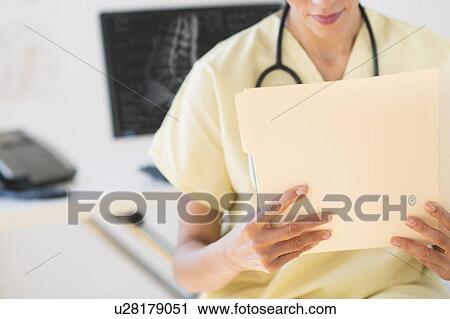 Portrait of doctor reading documents View Large Photo Image Stock Image - Portrait of doctor reading documents. Fotosearch