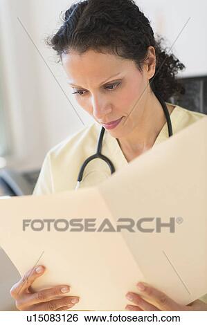 Portrait of doctor reading documents View Large Photo Image Stock Photograph - Portrait of doctor reading documents. Fotosearch