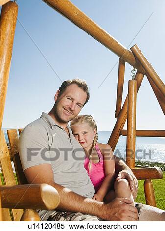 Portrait of father with daughter (4-5) on swing View Large Photo Image Stock Photography - Portrait of father with daughter (4-5) on swing. Fotosearch