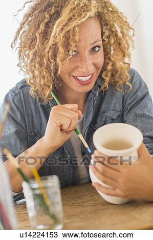 Portrait of female artist painting on ceramics in studio View Large Photo Image Stock Image - Portrait of female artist painting on ceramics in studio. Fotosearch