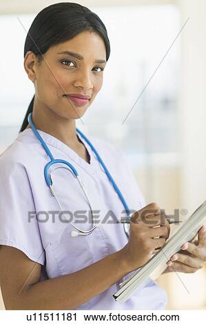 Stock Image - Portrait of female doctor. Fotosearch