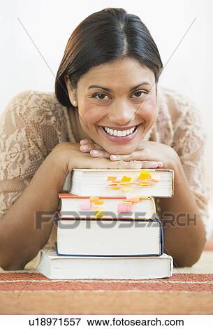 Portrait of female student leaning on books View Large Photo Image Stock Photo - Portrait of female student leaning on books. Fotosearch