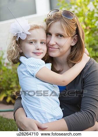 Stock Image - Portrait of mother holding her daughter. Fotosearch