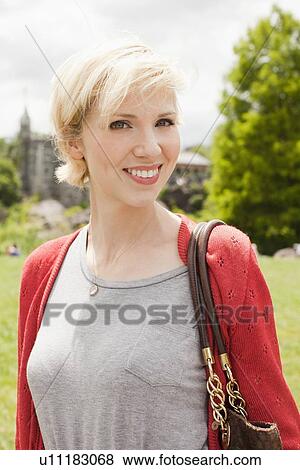 Stock Photo - Portrait of smiling woman in Central Park. Fotosearch