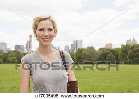 Stock Photo - Portrait of smiling woman in Central Park. Fotosearch