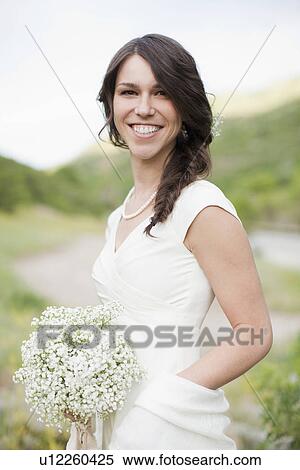 Portrait of smiling woman in white dress View Large Photo Image Stock Photography - Portrait of smiling woman in white dress. Fotosearch