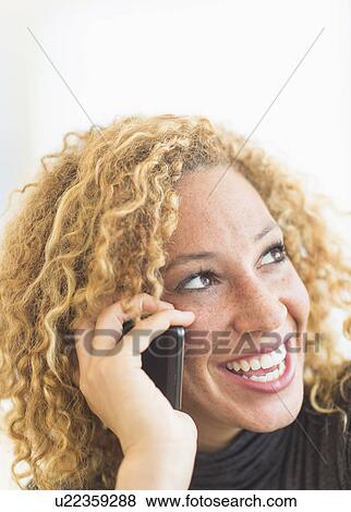 Portrait of smiling woman talking on mobile phone View Large Photo Image Stock Photo - Portrait of smiling woman talking on mobile phone. Fotosearch