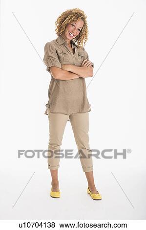 Stock Photo - Portrait of smiling young woman, studio shot. Fotosearch