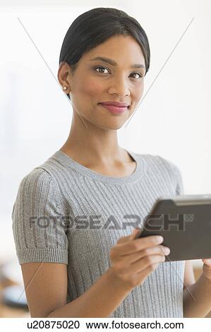 Portrait of woman holding digital tablet View Large Photo Image Stock Image - Portrait of woman holding digital tablet. Fotosearch