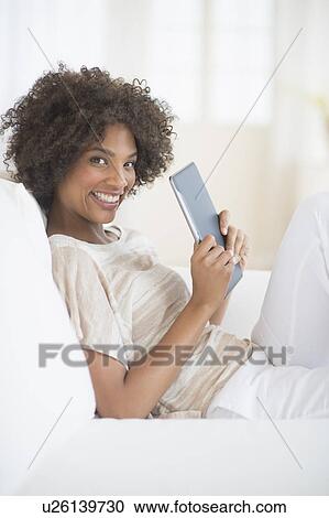 Portrait of woman holding digital tablet View Large Photo Image Stock Image - Portrait of woman holding digital tablet. Fotosearch