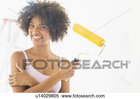 Portrait of woman holding paint roller View Large Photo Image Stock Photography - Portrait of woman holding paint roller. Fotosearch
