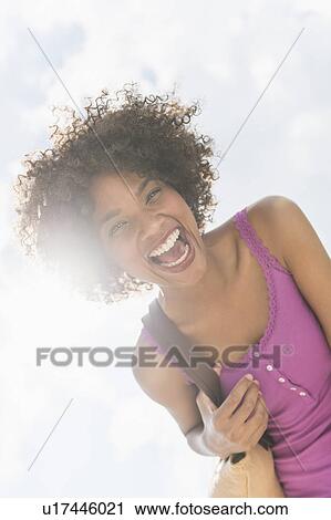 Stock Image - Portrait of woman laughing. Fotosearch
