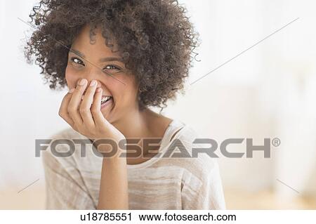 Stock Image - Portrait of woman laughing. Fotosearch
