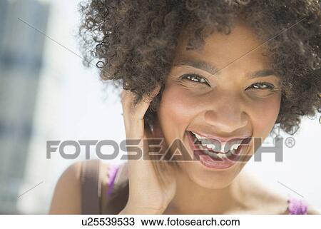 Stock Image - Portrait of woman laughing. Fotosearch