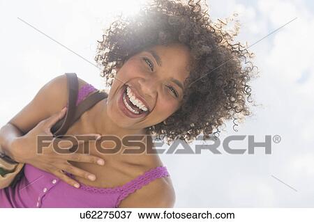 Stock Photo - Portrait of woman laughing. Fotosearch