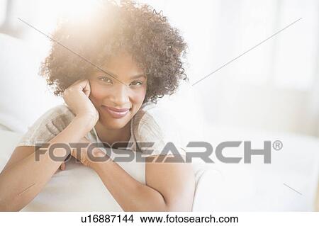 Portrait of woman relaxing on sofa View Large Photo Image Picture - Portrait of woman relaxing on sofa. Fotosearch