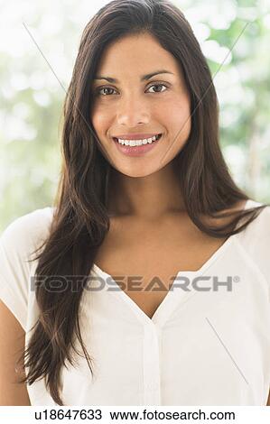Stock Image - Portrait of woman smiling. Fotosearch