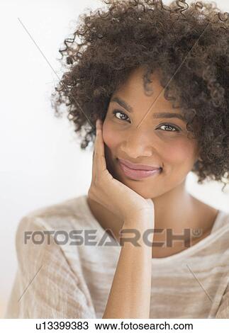Portrait of woman smiling, studio shot View Large Photo Image Stock Image - Portrait of woman smiling, studio shot. Fotosearch
