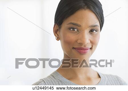 Portrait of woman smiling, studio shot View Large Photo Image Stock Photography - Portrait of woman smiling, studio shot. Fotosearch