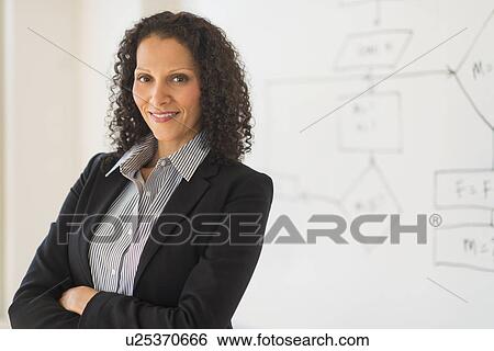 Portrait of woman standing next to whiteboard View Large Photo Image Stock Photograph - Portrait of woman standing next to whiteboard. Fotosearch