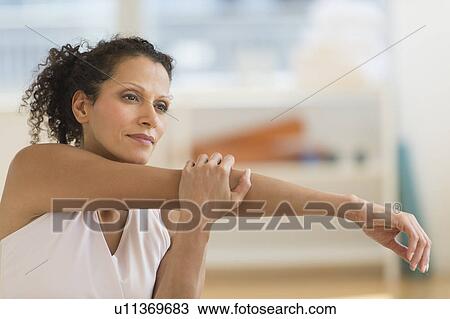 Portrait of woman stretching on exercise ball View Large Photo Image Stock Image - Portrait of woman stretching on exercise ball. Fotosearch